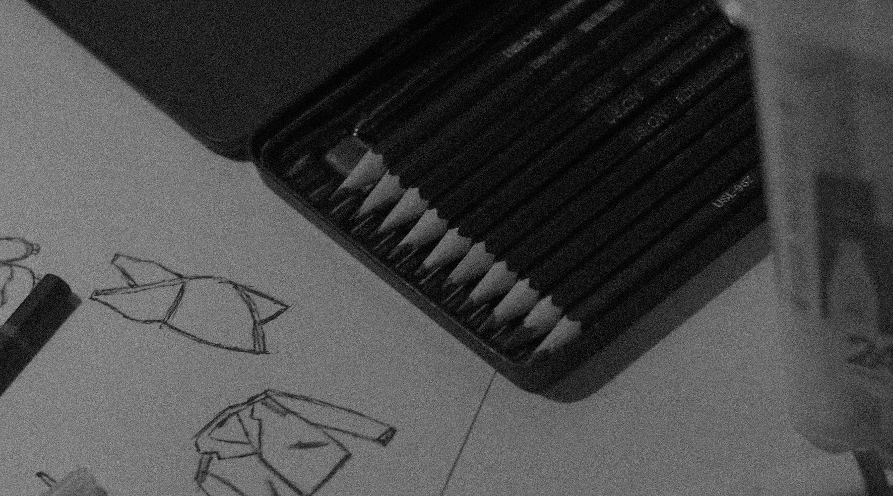 Books, paper, and study objects arranged on a dark surface